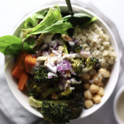 buddha bowl containing quinoa, chickpeas, roasted broccoli and sweet potato