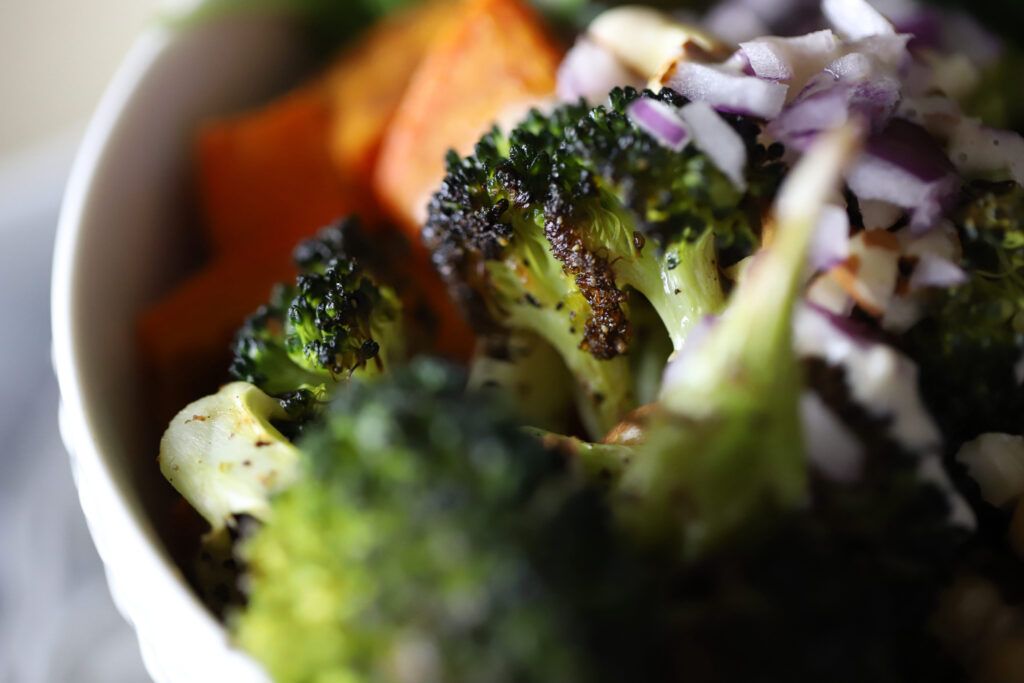 buddha bowl that contains a close up picture of roasted veggies