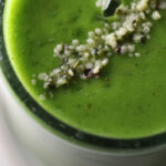 kiwi banana green smoothie in a glass cup