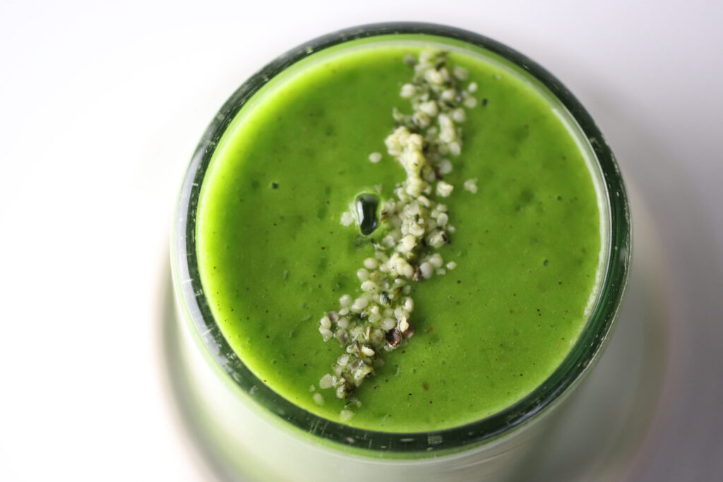 Kiwi banana green smoothie in a glass cup