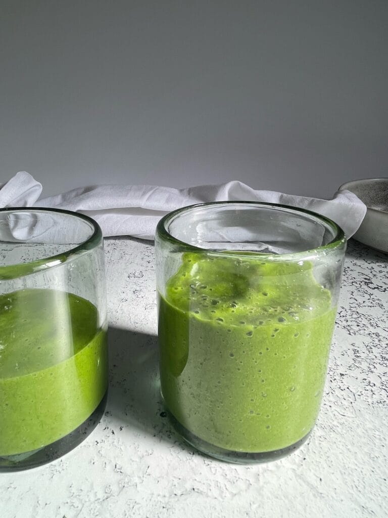kale mango smoothies in a glass cup