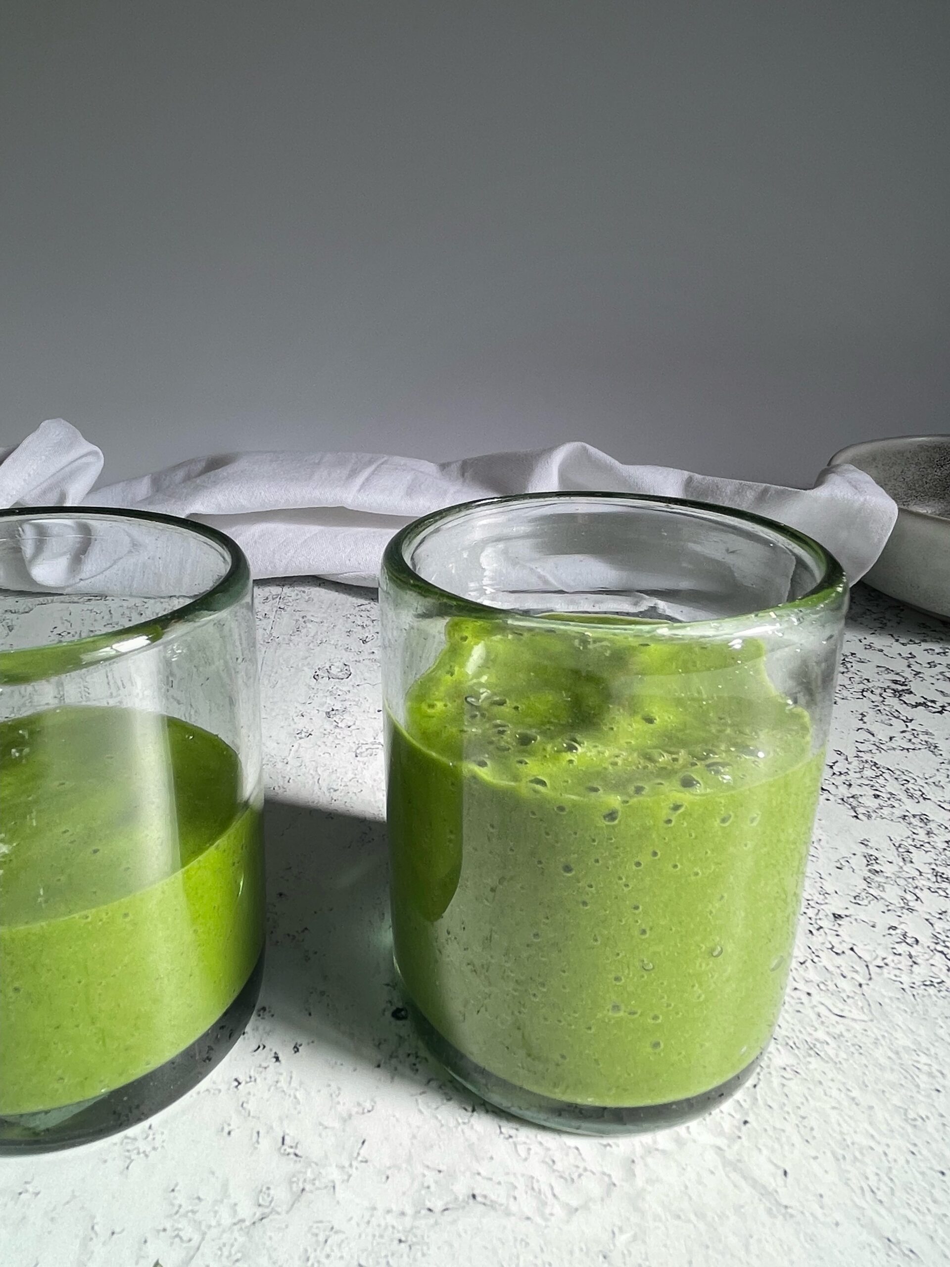 kale mango smoothies in a glass cup